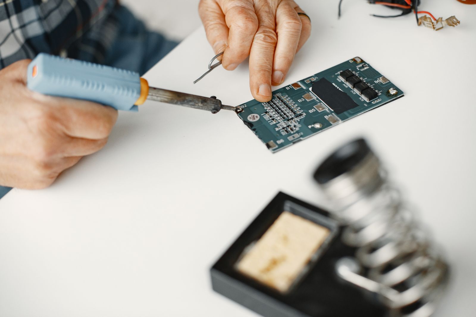 Técnico soldando un componente en una placa electrónica