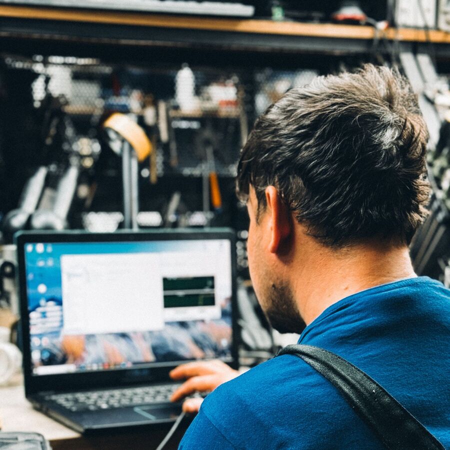 Technician providing IT support on a laptop